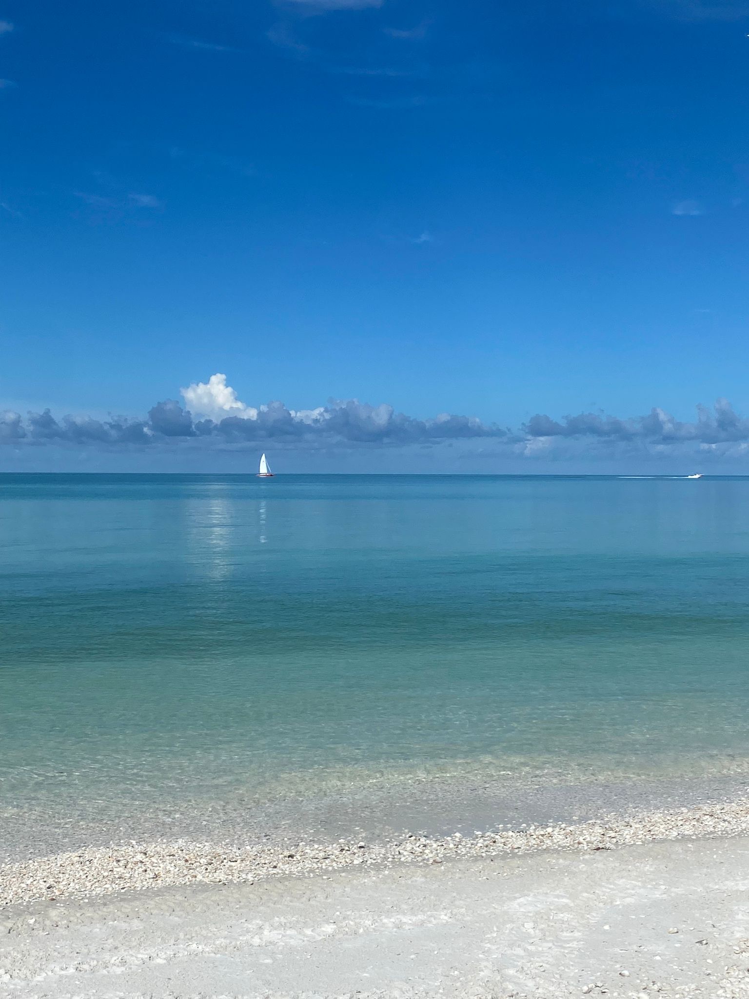 Calm turquoise Gulf water and white sand beach on Marco Island